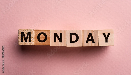 Wooden blocks with text MONDAY. Business banner. Start of the week. Pink backdrop. Flat lay.