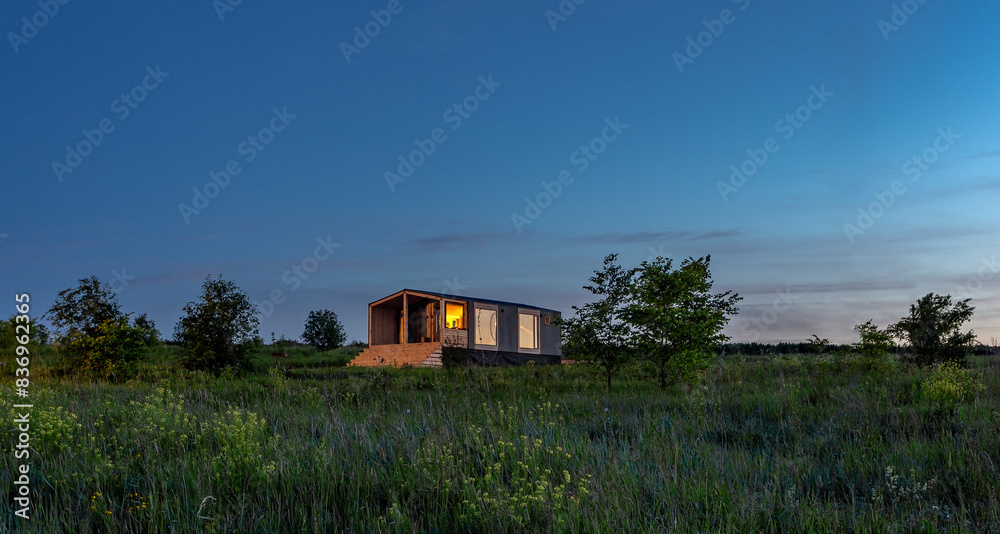 A-frame's style house in a field in a meadow. A-frame's style house in a field in a meadow.