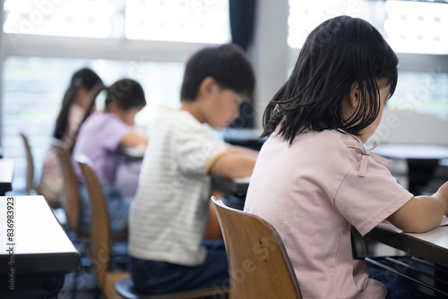 Obraz na plátně No face in profile of elementary school students studying in a bright classroom Plural people For the image of children taking exams, cramming, and studying at school