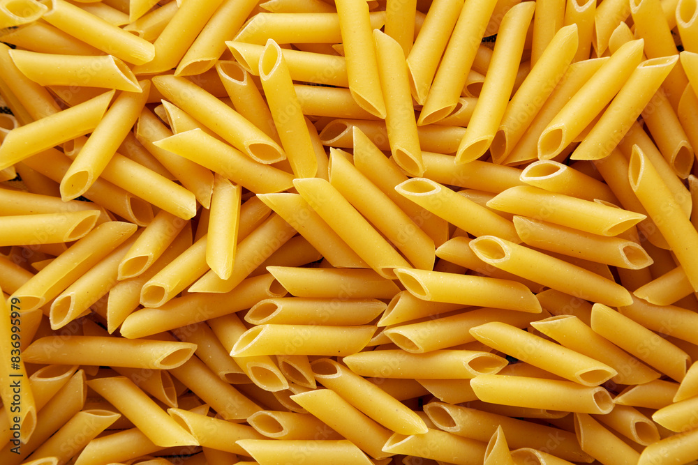 Raw Organic Dry Penne Pasta, top view. Overhead, flat lay, from above. Raw Organic Dry Penne Pasta, top view. Overhead, flat lay, from above.