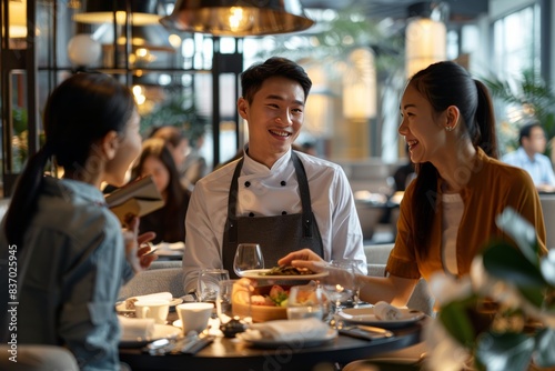 Show Chinese friends interacting with the staff at a chic restaurant