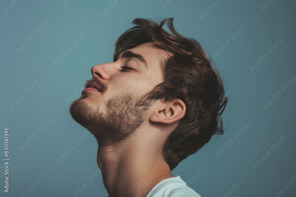 Fototapeta premium A close up of a man with beard and closed eyes looking to a side