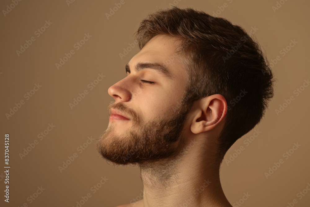 Fototapeta premium A close up of a man with beard and closed eyes looking to a side