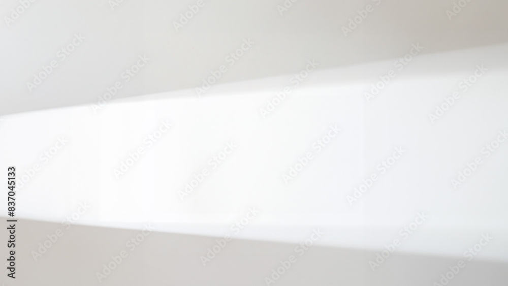Bright empty room with sunlight from the window. Showcase with shadow overlay effect Bright empty room with sunlight from the window. Showcase with shadow overlay effect