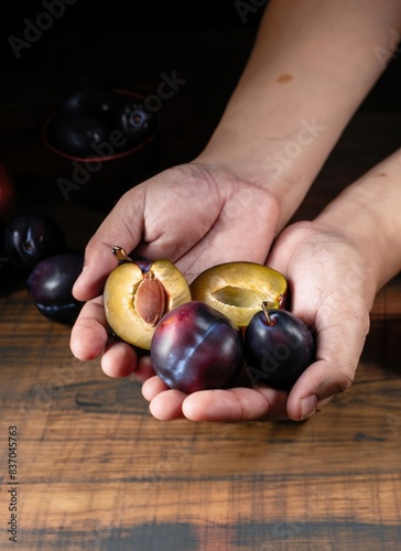 hands with handful of plumcots photo