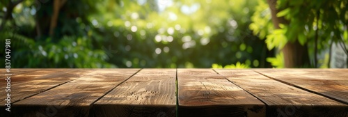 Wooden table with a green backyard in the background