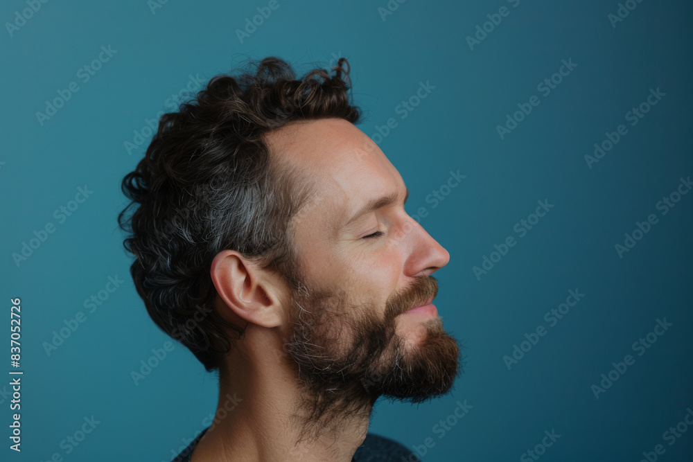 Fototapeta premium A close up of a man with beard and closed eyes looking to a side