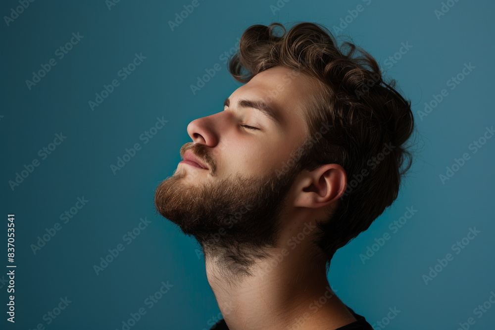Fototapeta premium A close up of a man with beard and closed eyes looking to a side