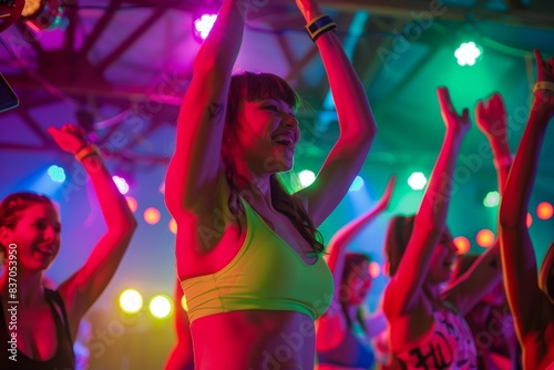 High-Energy Dance Fitness Class with Colorful Lights and Enthusiastic Participants © spyrakot