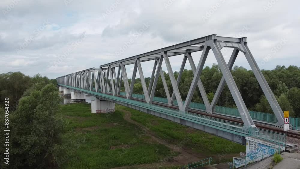 Railway bridge over the river among trees and fields Railway bridge over the river among trees and fields
