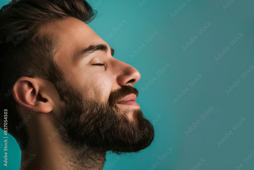 Fototapeta premium A close up of a man with beard and closed eyes looking to a side
