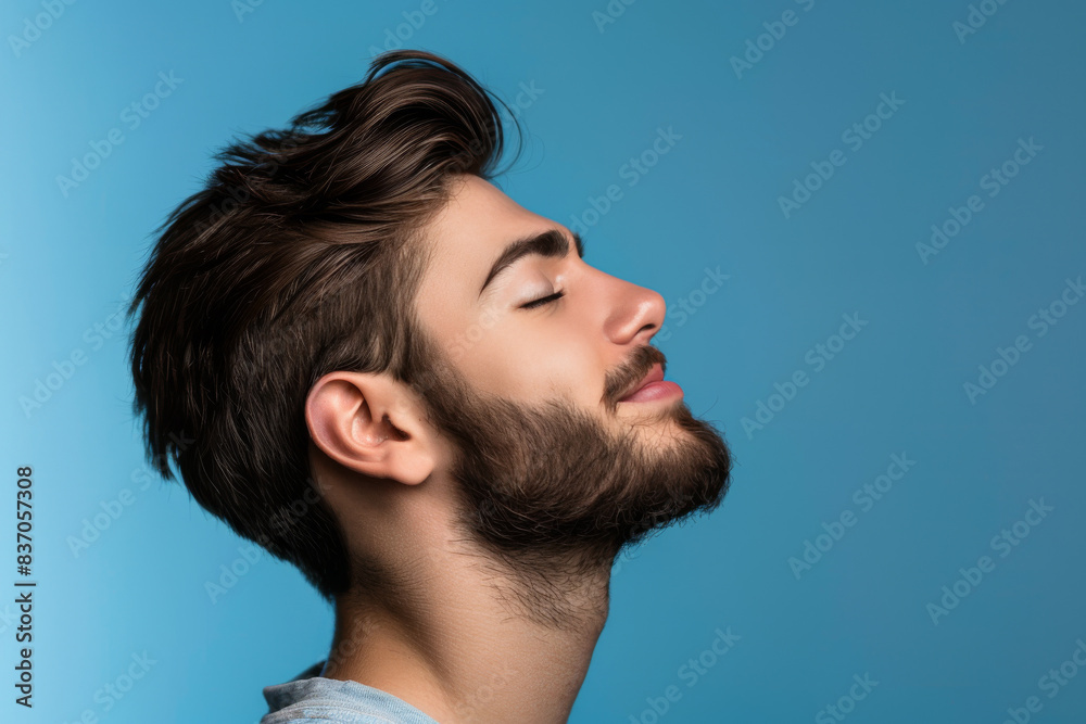 Fototapeta premium A close up of a man with beard and closed eyes looking to a side