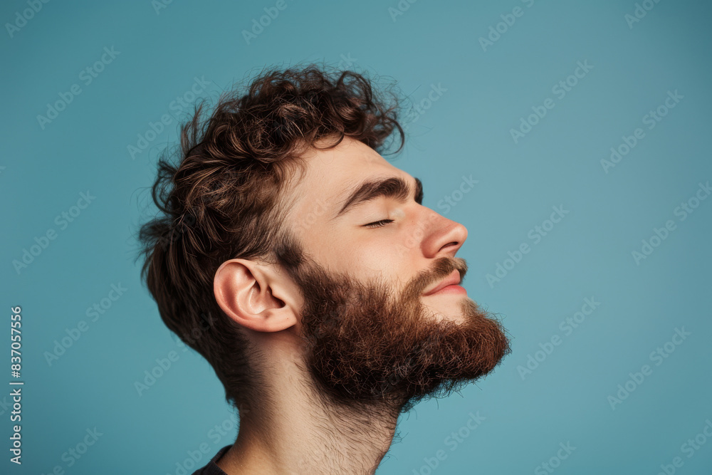 Fototapeta premium A close up of a man with beard and closed eyes looking to a side