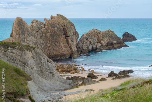 Panoramic of Arnía beach and Canales de los Urros with rock formations at low tide in a cloudy weather in Costa Quebrada near Santander, Cantabria, North Spain. photo
