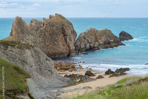 Panoramic of Arnía beach and Canales de los Urros with rock formations at low tide in a cloudy weather in Costa Quebrada near Santander, Cantabria, North Spain.