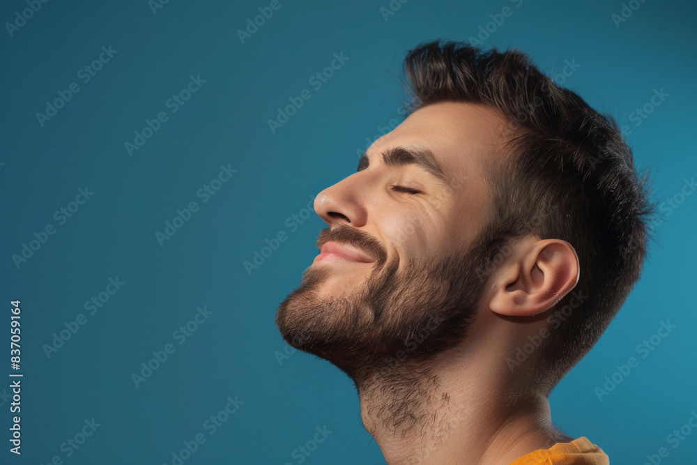 A close up of a man with beard and closed eyes looking to a side A close up of a man with beard and closed eyes looking to a side