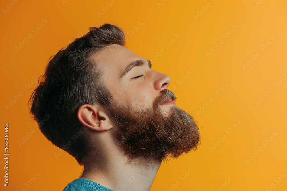 Obraz premium A close up of a man with beard and closed eyes looking to a side