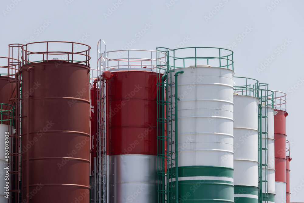 A row of tanks with red, white and green colors A row of tanks with red, white and green colors