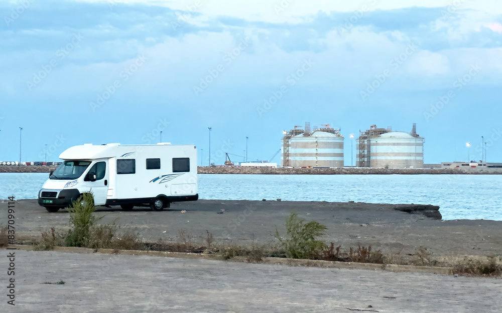 Campervan parking at beach at coastline in Port Sagunto, Valencia Spain. Family camper van at seaside. Motorhome lifestyle travel to sea. Traveling on Campervan along coast. Caravaning Parking at sea Campervan parking at beach at coastline in Port Sagunto, Valencia Spain. Family camper van at seaside. Motorhome lifestyle travel to sea. Traveling on Campervan along coast. Caravaning Parking at sea