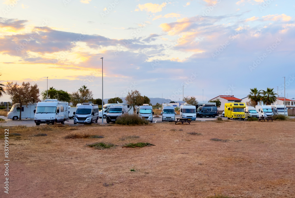 Campervan in camp parking near beach at coastline. Family rv camper van vehicle at seaside. Rving motorhome lifestyle travel to sea. Travel on Campervan along Spain coast. Caravaning Parking. Camping Campervan in camp parking near beach at coastline. Family rv camper van vehicle at seaside. Rving motorhome lifestyle travel to sea. Travel on Campervan along Spain coast. Caravaning Parking. Camping