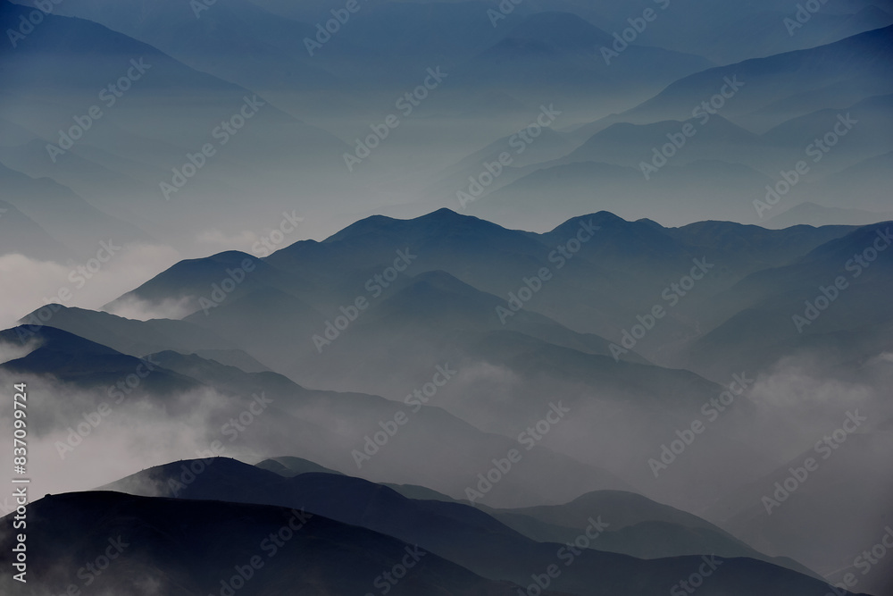 The Andes Mountains shrouded in fog create a mystical and ethereal atmosphere. As the mist weaves through the peaks and valleys, it adds an element of mystery.