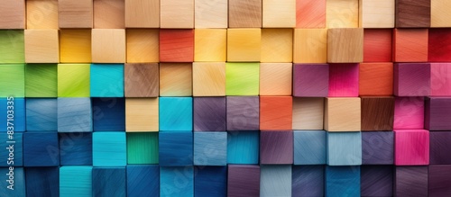 Header image or cover image for something creative or diverse. A Spectrum of multi-colored wooden blocks aligned