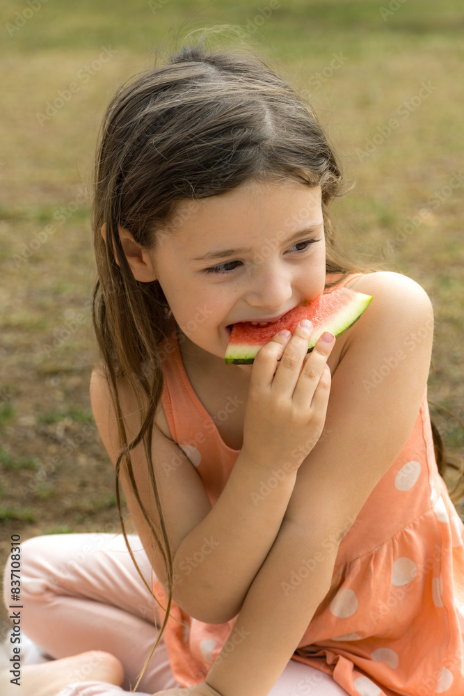 Summer in the Park: Little Girl Enjoying Summer Eating Watermelon Summer in the Park: Little Girl Enjoying Summer Eating Watermelon