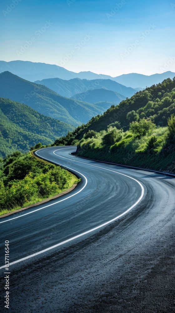 Fototapeta premium Winding Road Through Mountain Pass on a Sunny Day