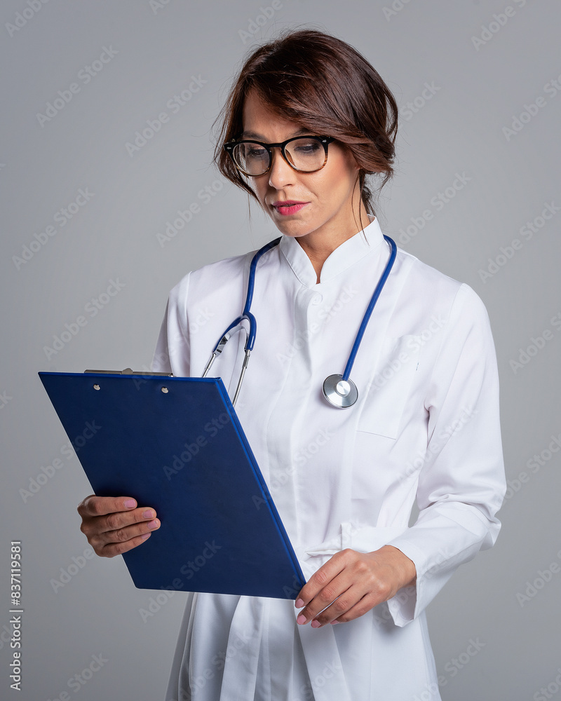 Female doctor studio portrait against isolated background Female doctor studio portrait against isolated background