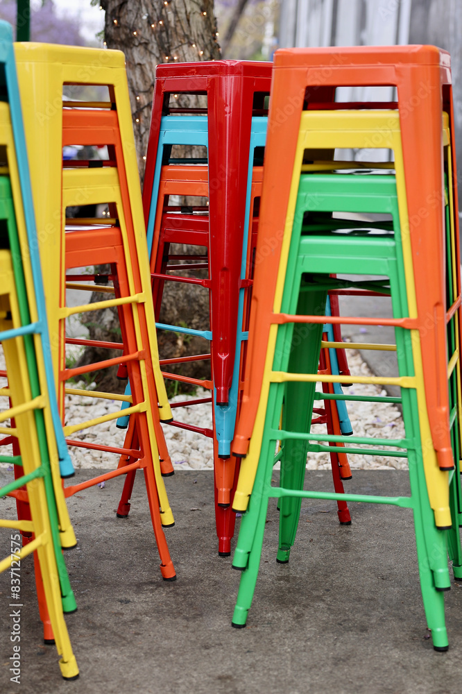 stacks of brightly colored metal bar stools