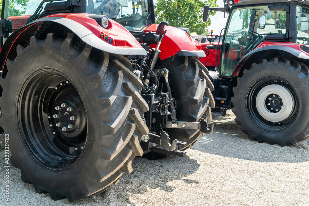 Row of red agricultural tractors for sale. Row of red agricultural tractors for sale.