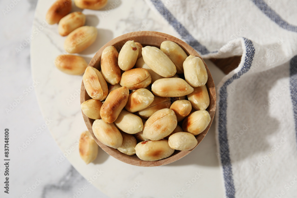 Roasted peanuts in bowl on white marble table, top view Roasted peanuts in bowl on white marble table, top view