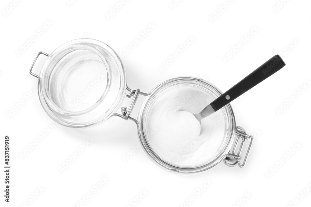 Baking soda and spoon in glass jar isolated on white, top view Baking soda and spoon in glass jar isolated on white, top view