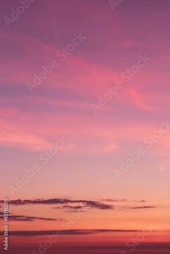 Dramatic soft sunrise  sunset pink violet orange sky with clouds background texture