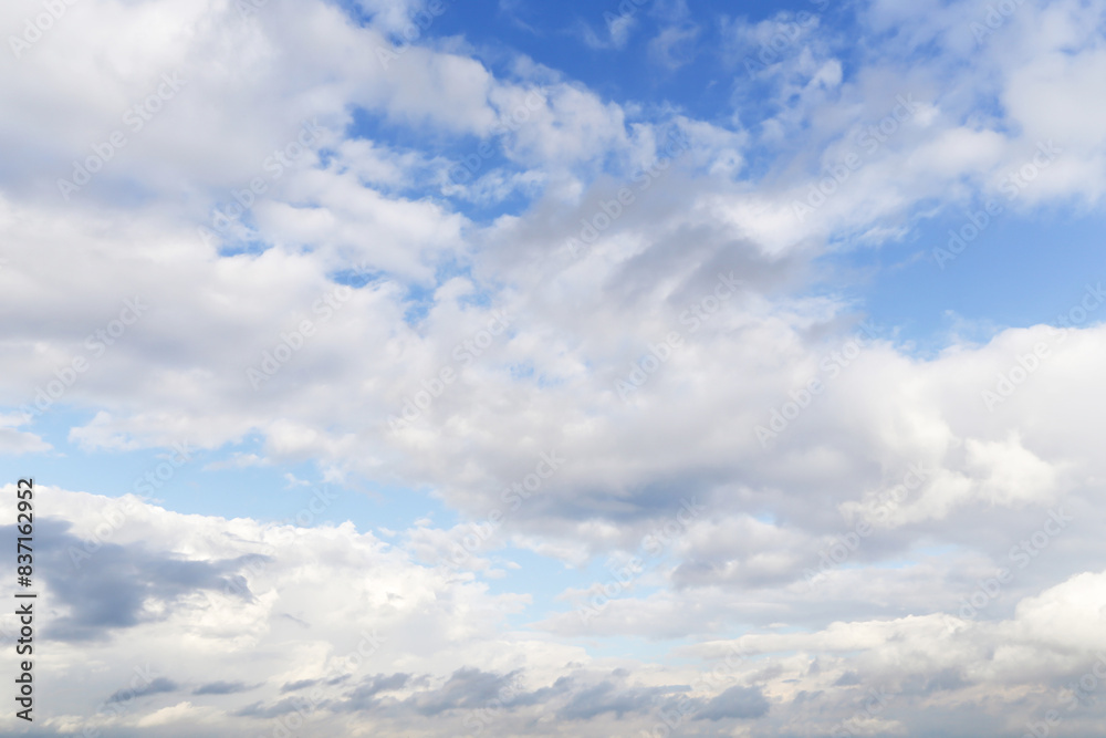 Blue cloudy sky with many white fluffy cumulus clouds texture, background Blue cloudy sky with many white fluffy cumulus clouds texture, background