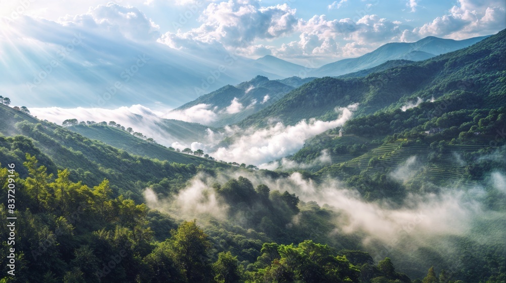 Misty mountains with sunlight streaming through clouds Misty mountains with sunlight streaming through clouds