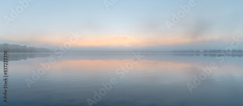Wallpaper Mural landscape of a misty morning by a tranquil lake, with a soft focus background of distant trees Torontodigital.ca