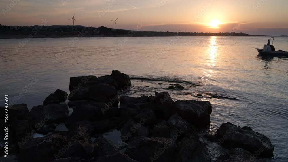 Tranquil sea view at sunset. Silhouette of fishing boats and wind turbines in the background. Turkey Blacksea shore. 4k video Tranquil sea view at sunset. Silhouette of fishing boats and wind turbines in the background. Turkey Blacksea shore. 4k video