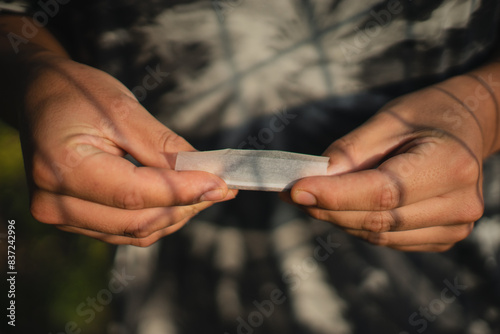 closeup hands rolling a tobacco cigar