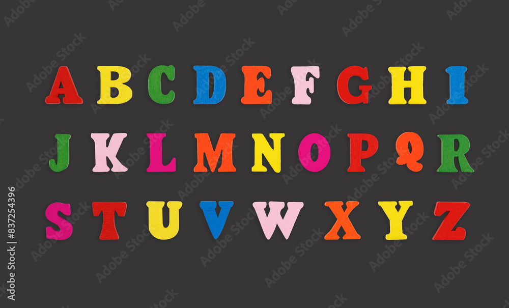 wooden letters of the English alphabet multi-colored on a grey background wooden letters of the English alphabet multi-colored on a grey background