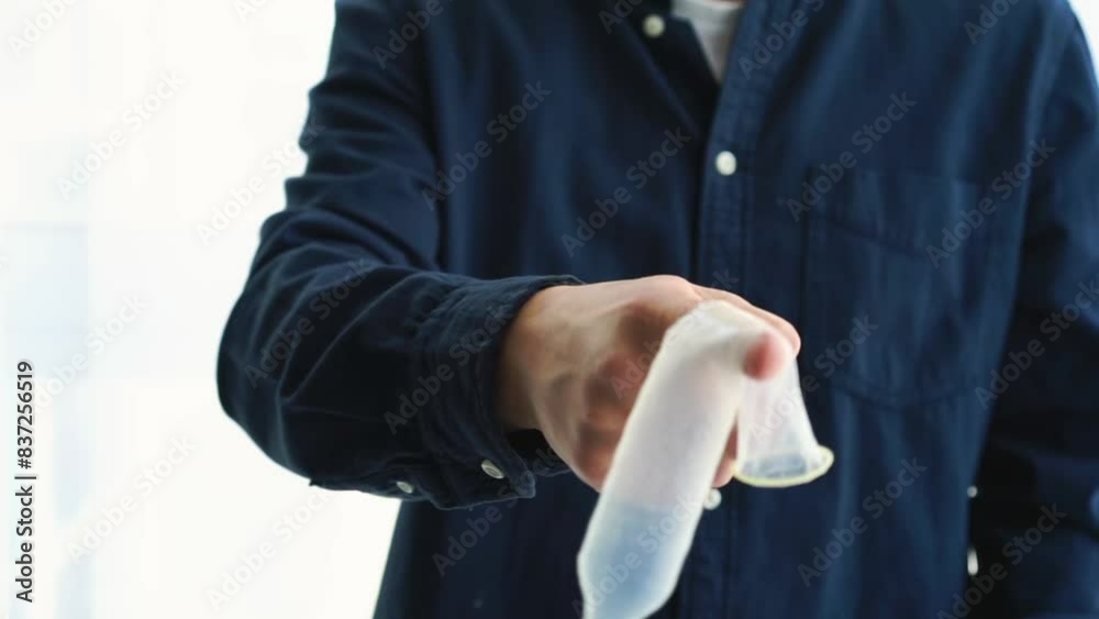a man holds an unwrapped condom in his hands.
Method of contraception a man holds an unwrapped condom in his hands.
Method of contraception