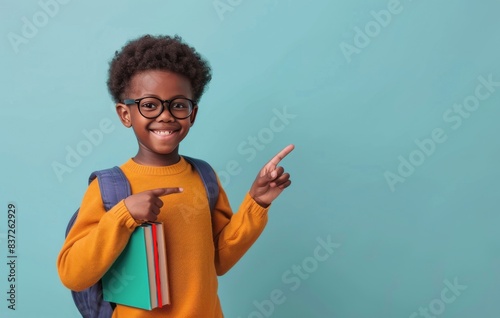 Smiling Young Girl Wearing Glasses Holds Textbook Against Blue Background