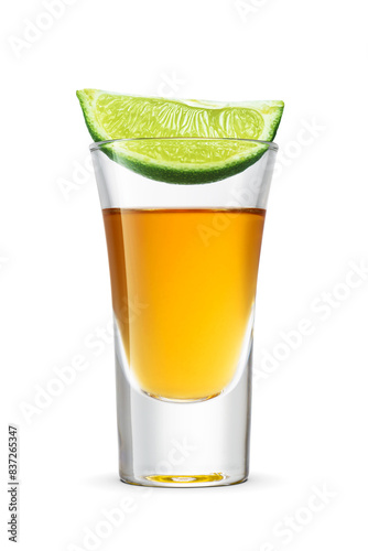 Golden tequila shot with green lime wedge on isolated. Transparent PNG image. photo