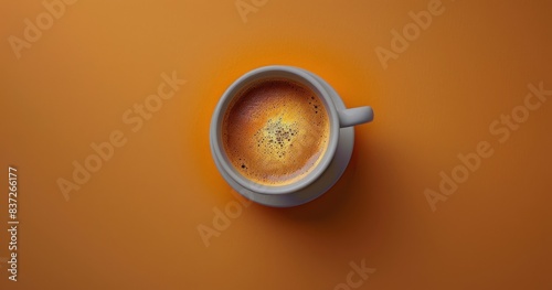 Top View of a Cup of Coffee With Cinnamon Sprinkles on an Orange Background