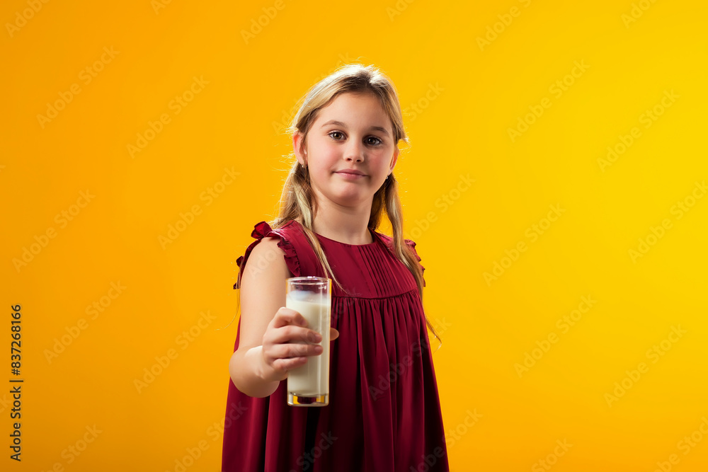 Child girl holding glass of milk. Nutrition and health concept Child girl holding glass of milk. Nutrition and health concept