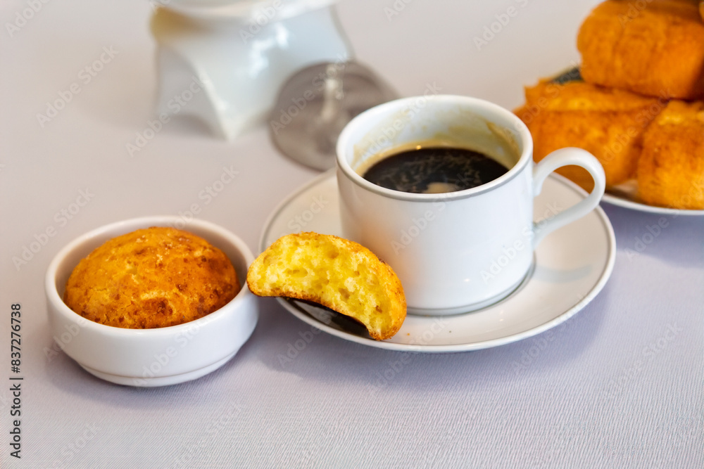 Afternoon coffee served in a white cup with cornbread or cheese bread Afternoon coffee served in a white cup with cornbread or cheese bread