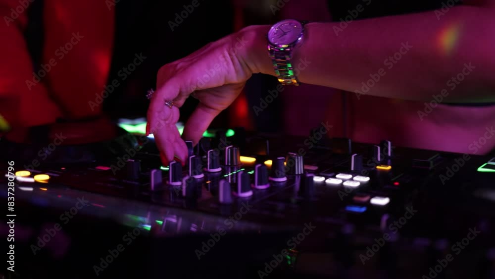 control DJ for mixing music with blurred people dancing at party in nightclub. control DJ for mixing music with blurred people dancing at party in nightclub.