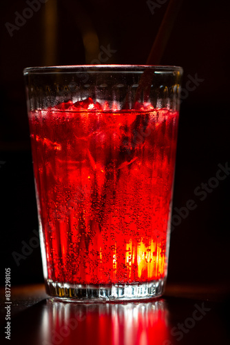 couple glasses with alcohol fruit ice cold drink, bright red refreshing cold drink