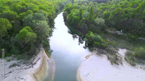 Aerial footage of the lovely sandy beaches at the mouth of Kamchiya river near the city of Varna in Bulgaria. Kamchia beaches seen from a drone. Flyover shot of empty black sea beach by a forrest.
 photo