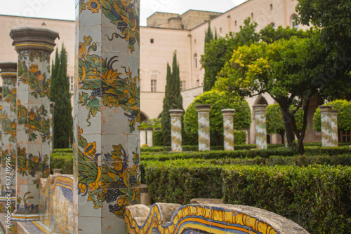  Beautiful tiled pillars and the bench with fine decorations on maiolics plated at the cloister garden of Santa Chiara Monastery, Naples, Italy. Vacation in Italy photo